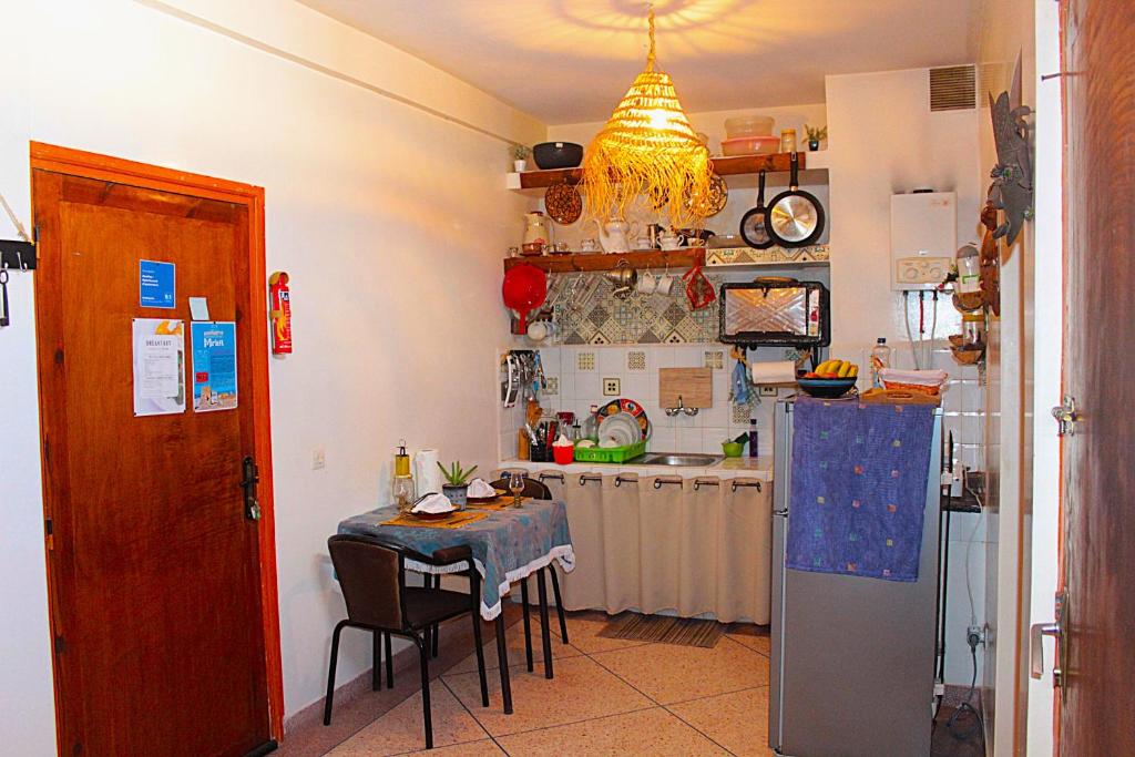 a kitchen with a table and a refrigerator at Asunfou : Appartement d'apaisement in Mirleft