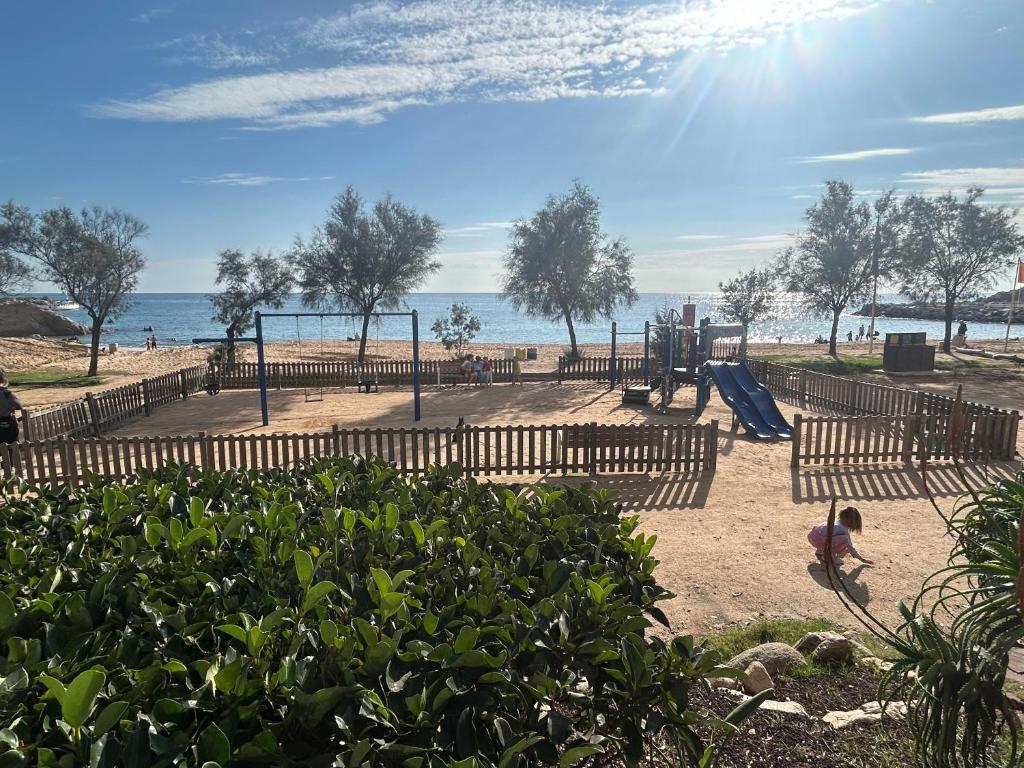 a playground at the beach with at Canyelles BBQ Apartment in Lloret de Mar