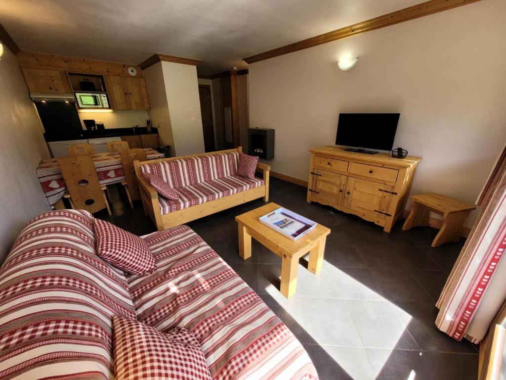 un salon avec un canapé et une télévision dans l'établissement Résidence Le Criterium - 3 Pièces pour 6 Personnes MAE-4391, à Lanslebourg-Mont-Cenis