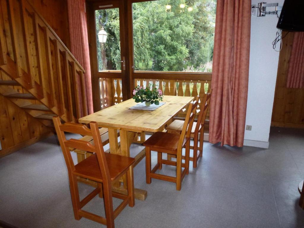 - une table et des chaises en bois dans une chambre avec fenêtre dans l'établissement Résidence Parrachee - 2 Pièces pour 6 Personnes MAE-4611, à Val Cenis