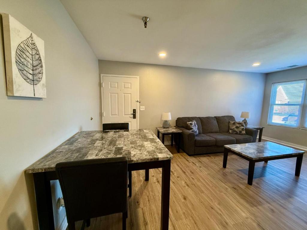 a living room with a table and a couch at Aksarben View Gem-Near UNO in Omaha