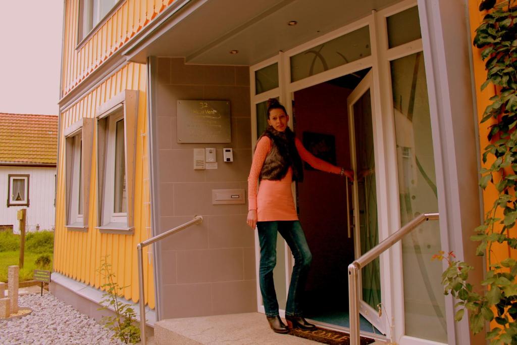 a woman standing in the doorway of a house at Haus Veni in Bad Grund