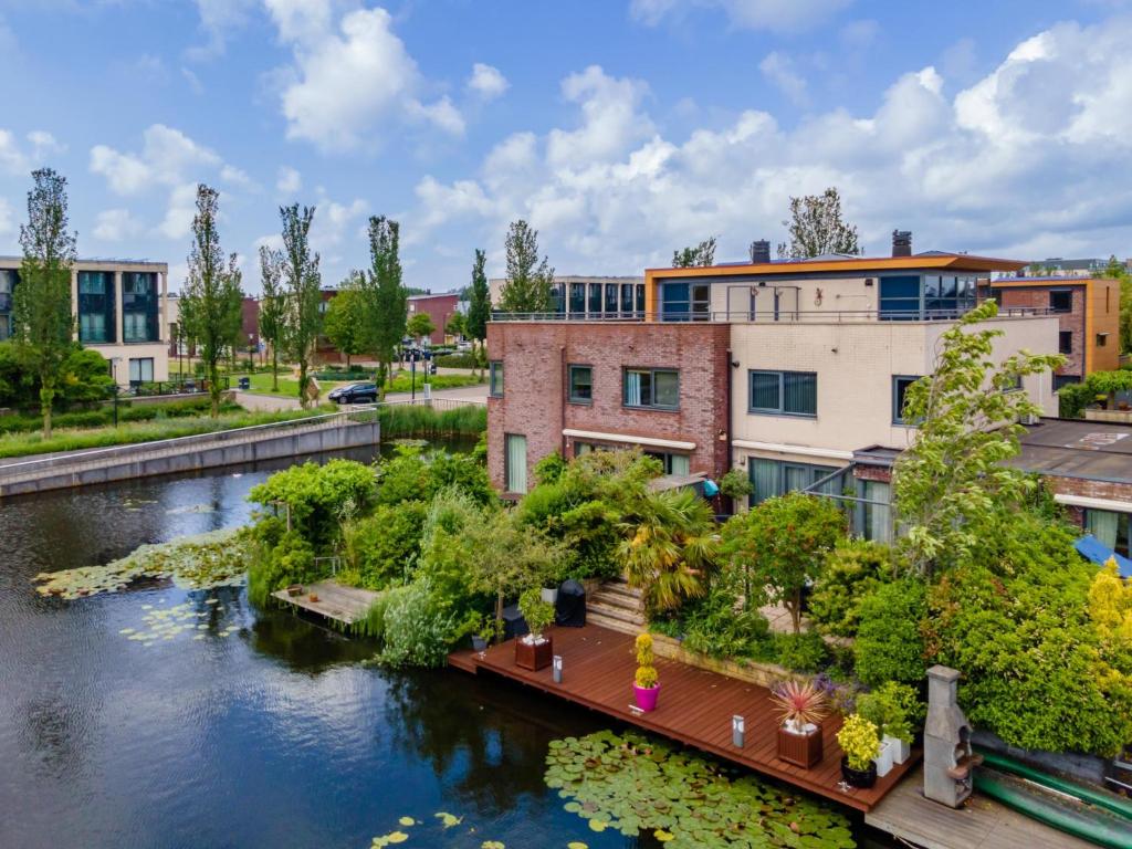 an apartment building with a bridge over a river at Alkmaar aan het Water in Alkmaar