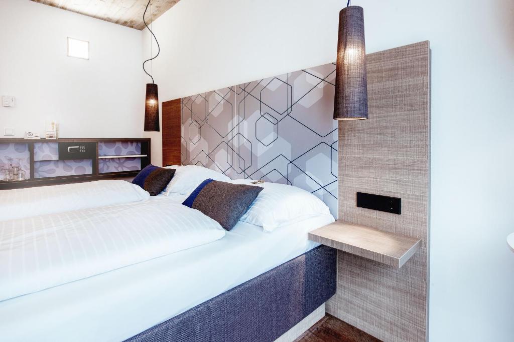 Postel nebo postele na pokoji v ubytování arte Hotel Kufstein