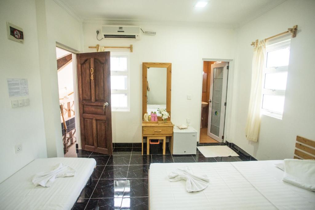 Postel nebo postele na pokoji v ubytování Faza View Inn, Maafushi