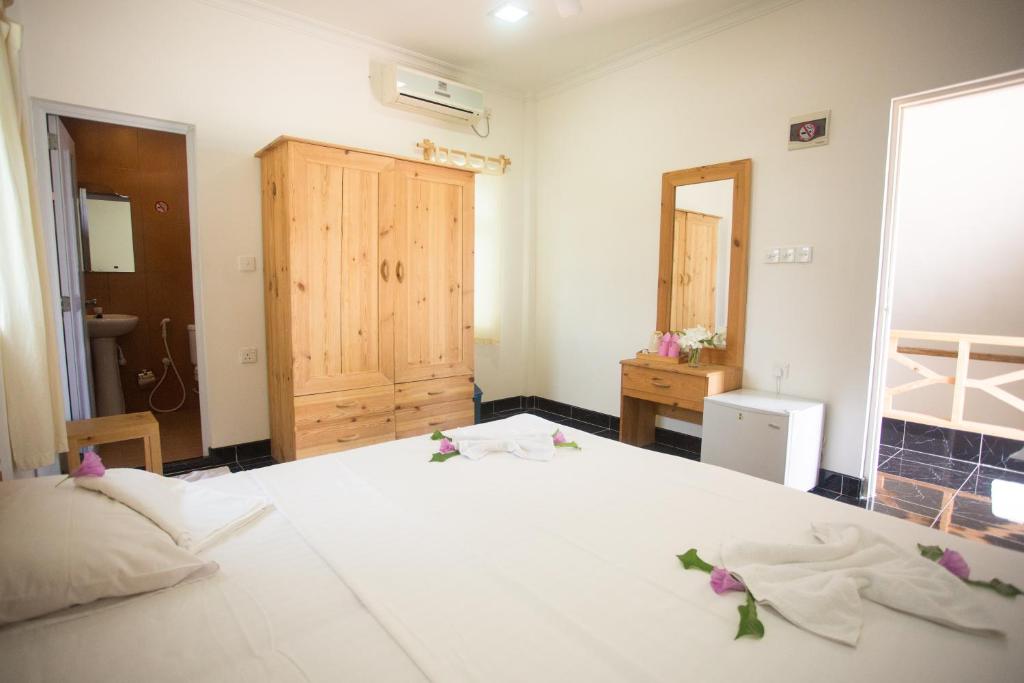 Postel nebo postele na pokoji v ubytování Faza View Inn, Maafushi