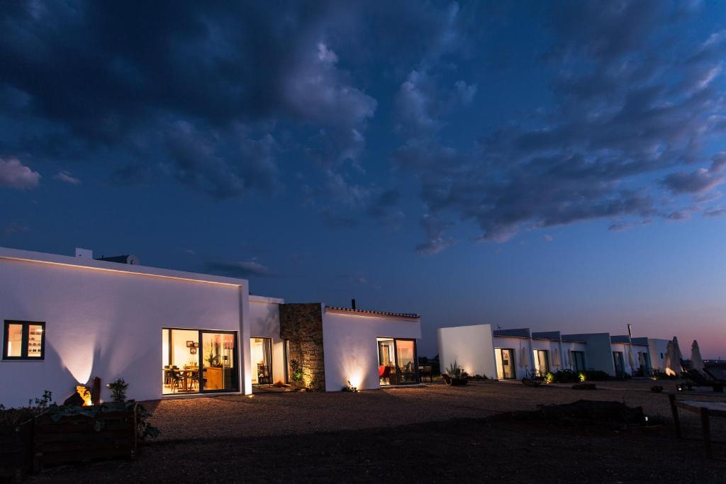 a row of white buildings at night at Agroturismo Xistos in Cerca