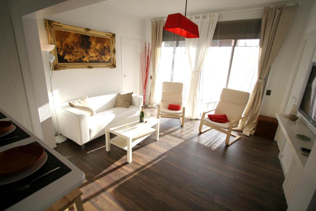 バルセロナにあるNear Clot & Sagrada Familia Apartmentのリビングルーム(白いソファ、椅子2脚付)