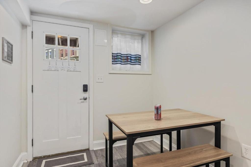 a small room with a table and a door at Garden-Level 2-BR Apt in Historic Petworth Home in Washington, D.C.