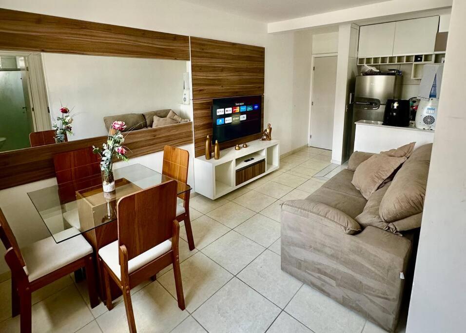 uma sala de estar com um sofá e uma mesa em Aconchegante apt em Joao Pessoa em João Pessoa