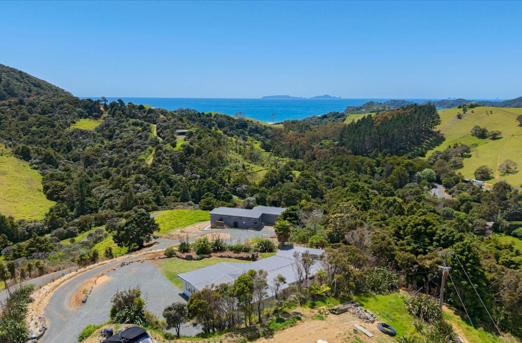 an aerial view of the property with the ocean in the background at Waitorupai Retreat 2 - Sandy Bay Holiday Home in Whangarei
