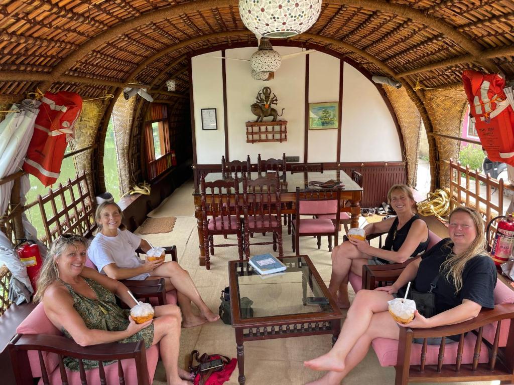 a group of women sitting in chairs in a room at Thara's Houseboat in Alleppey