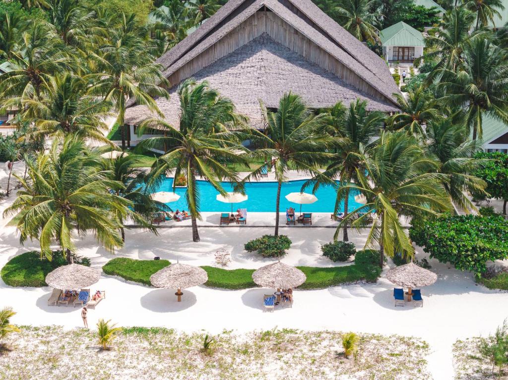 an aerial view of a resort with palm trees and a pool at Kisiwa on the Beach in Paje
