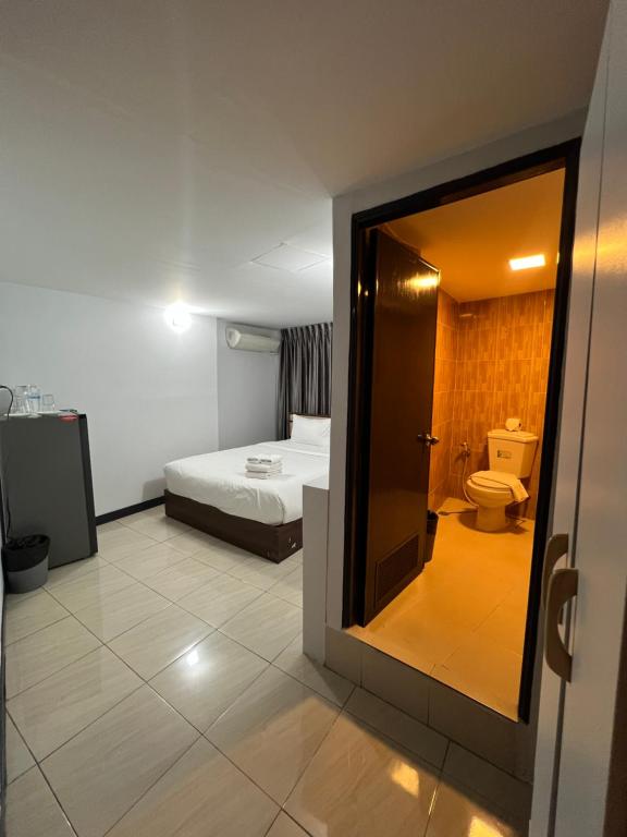 a hotel room with a bed and a toilet at Maland House Hostel - Pattaya soi 14 Saisong Road in Pattaya South