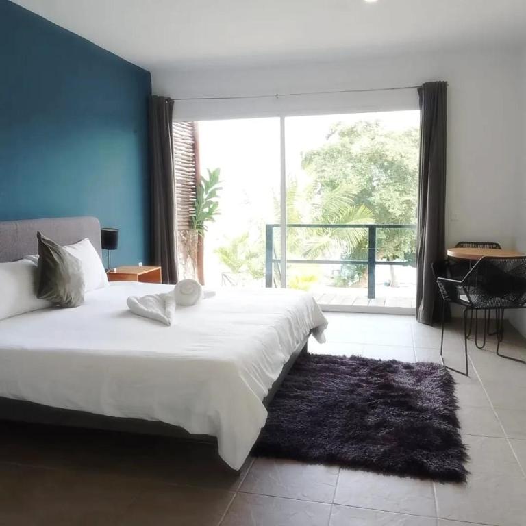 Postel nebo postele na pokoji v ubytování Hotel Xurús Bacalar