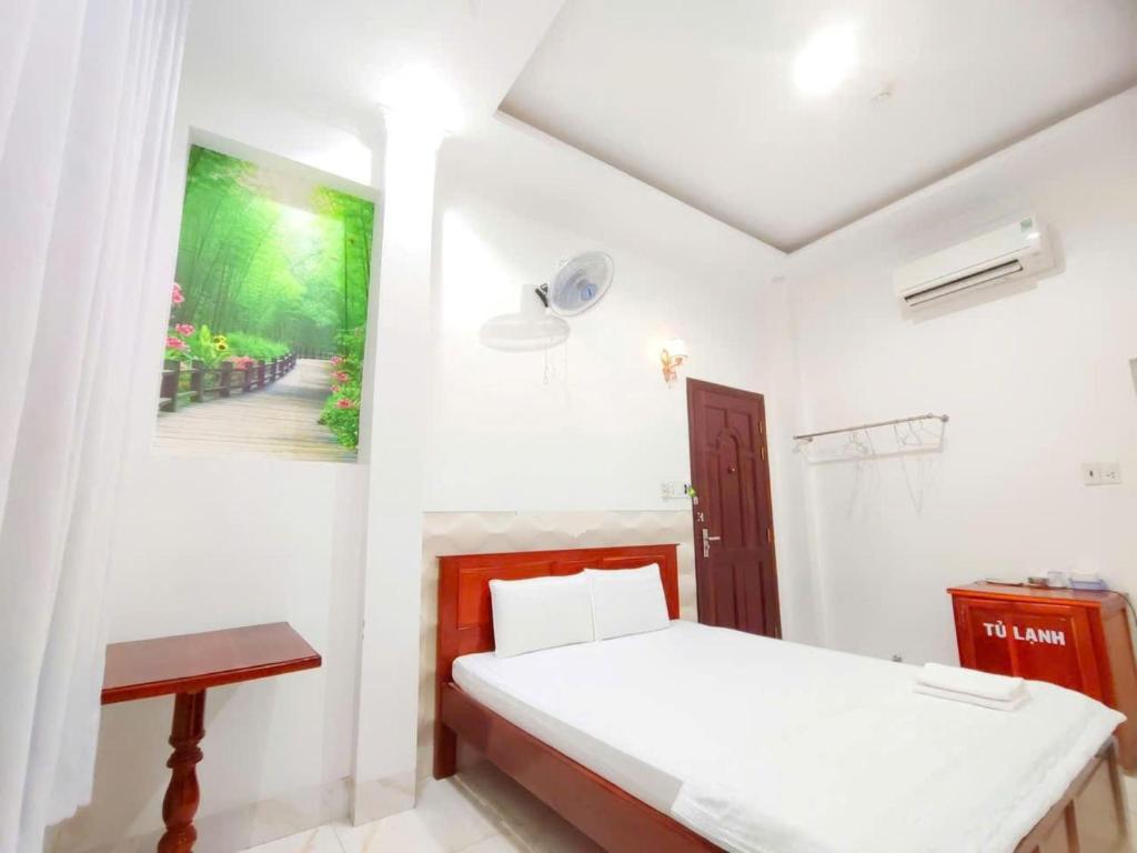 Postel nebo postele na pokoji v ubytování Sao Mai Hotel Can Tho
