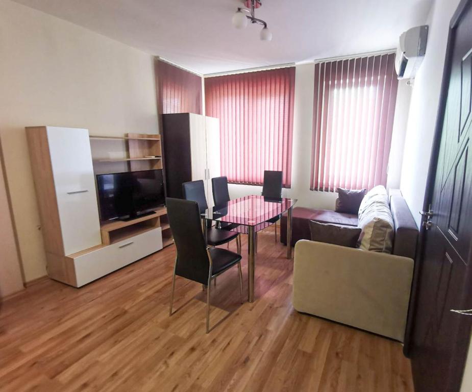 a living room with a table and a couch at Central Apartment 4 in Stara Zagora