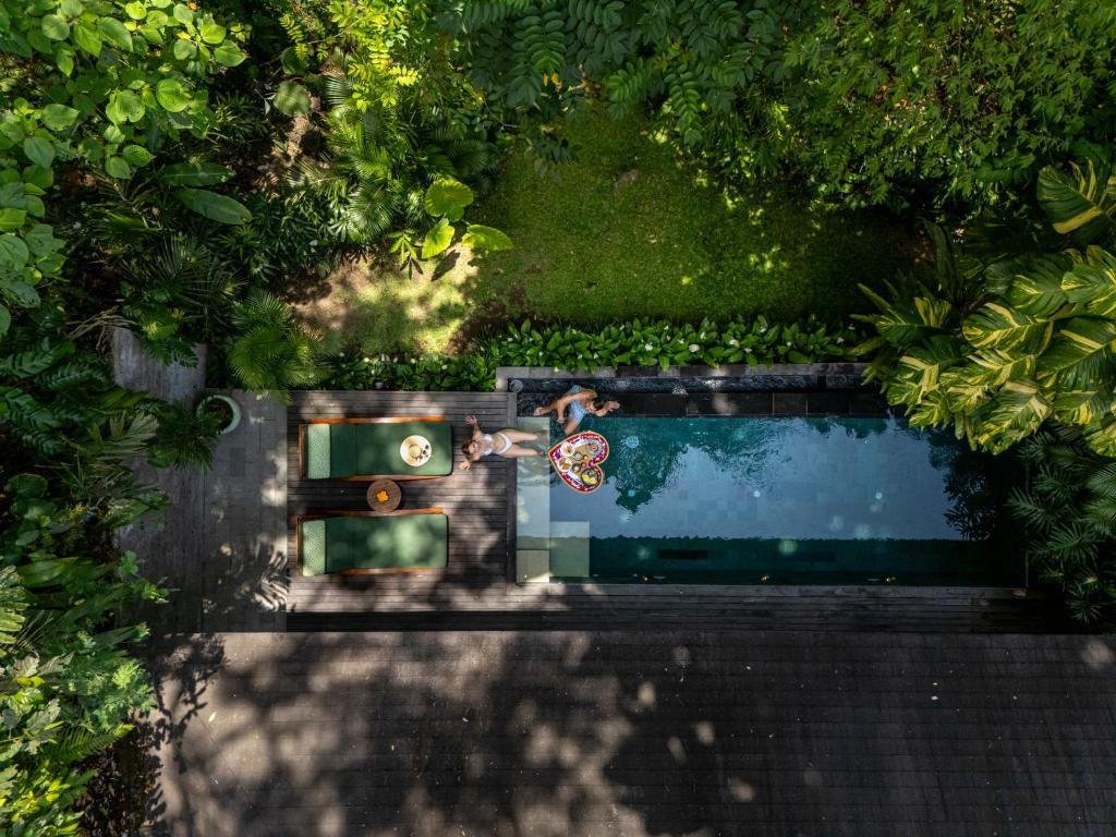 an overhead view of a person swimming in a pool at Suweta Villa Ubud in Ubud