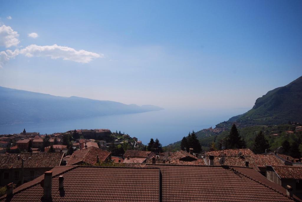 a view of a village with mountains in the background at Appartamento Cristina - Theater Home in Tignale