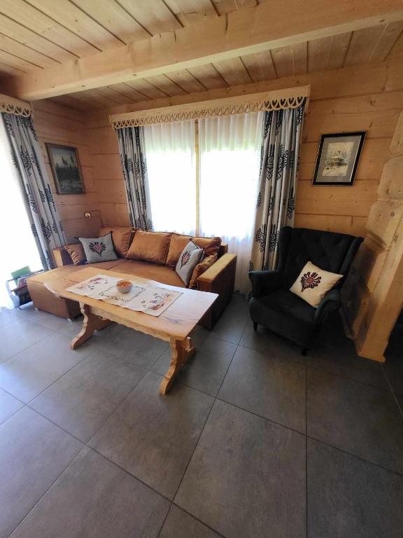a living room with a couch and a table at BIAŁY PUCH in Zakopane