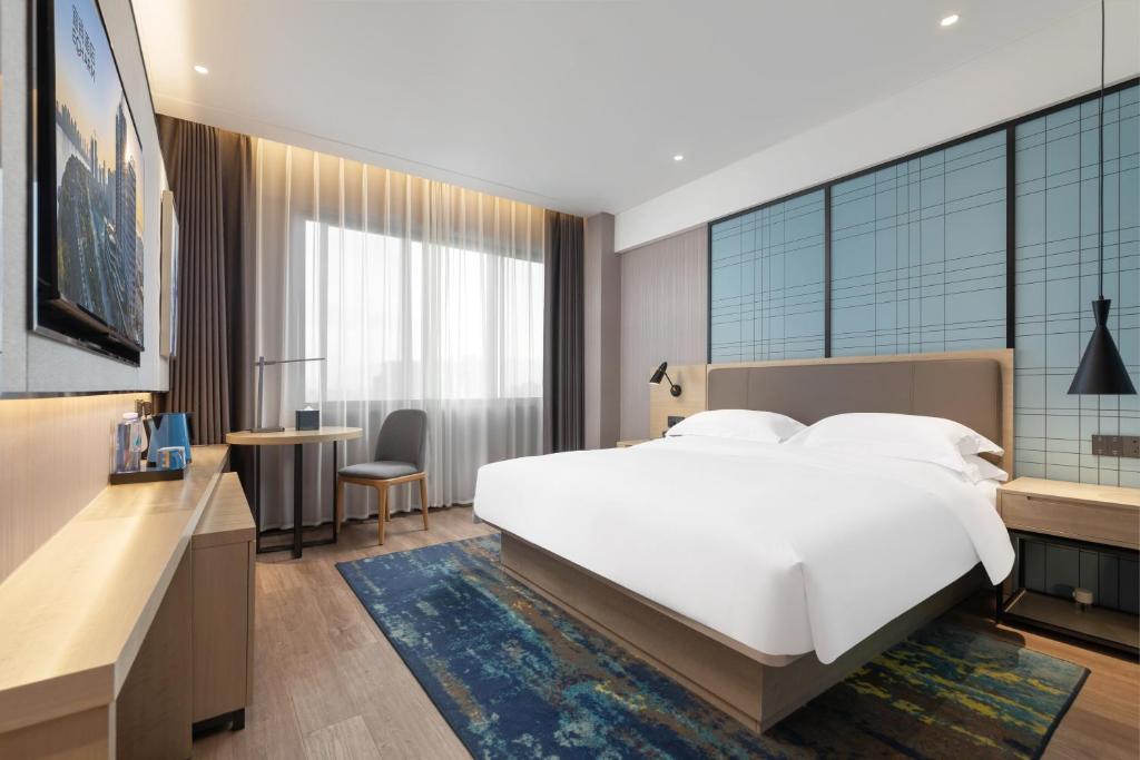 Postel nebo postele na pokoji v ubytování Yishang Hotel Hanzhong Wetland Park Branch
