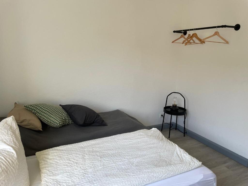 a bedroom with a bed and a shelf on the wall at Bigge Elements Gästezimmer 4 "Westen" 4 Personen in Olpe
