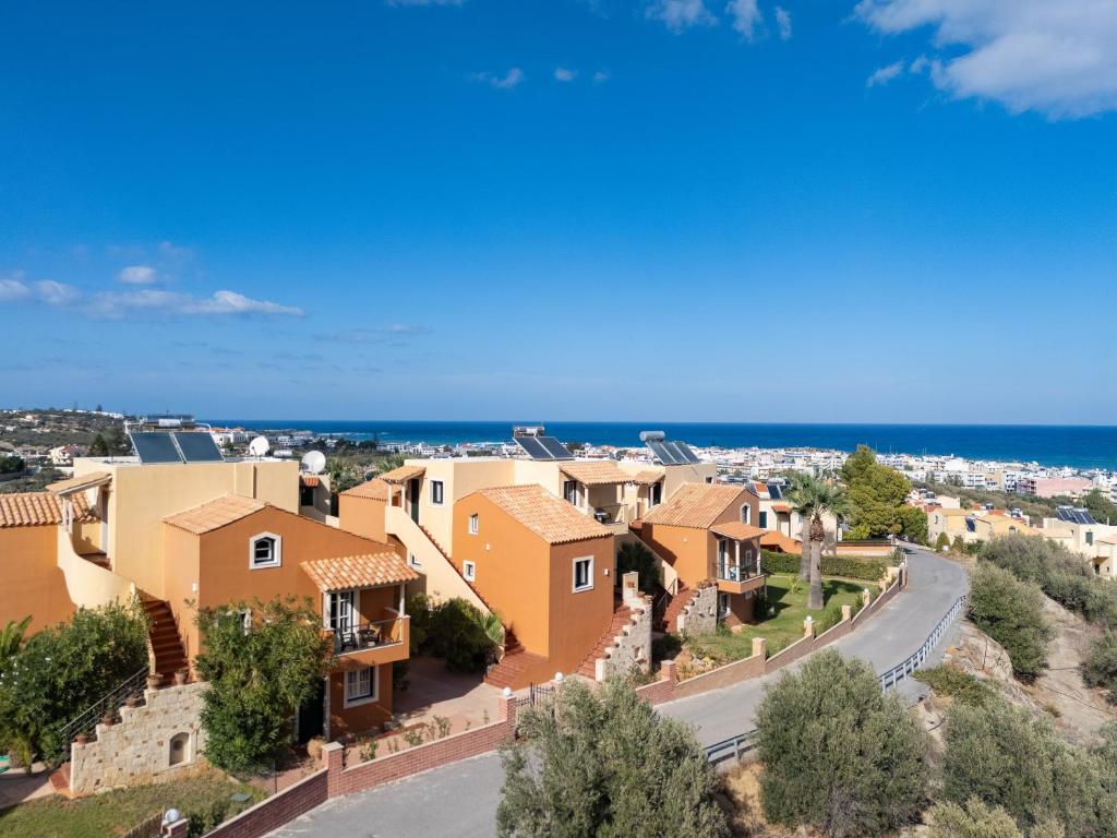 arial view of a village with houses and the ocean at Dia Apartments in Hersonissos
