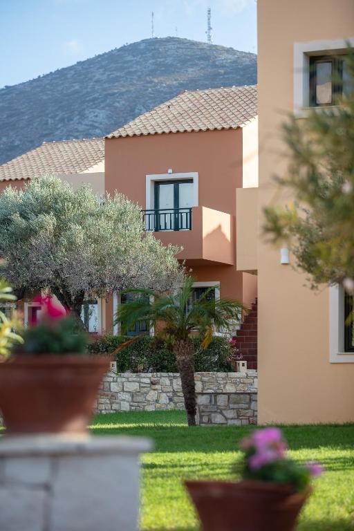 a building with trees and plants in a yard at Dia Apartments in Hersonissos