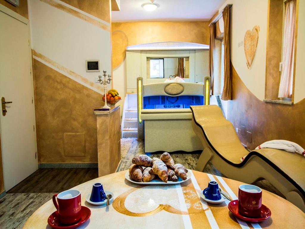 a kitchen with a table with a plate of food on it at Hotel Butterfly in Torre del Lago Puccini
