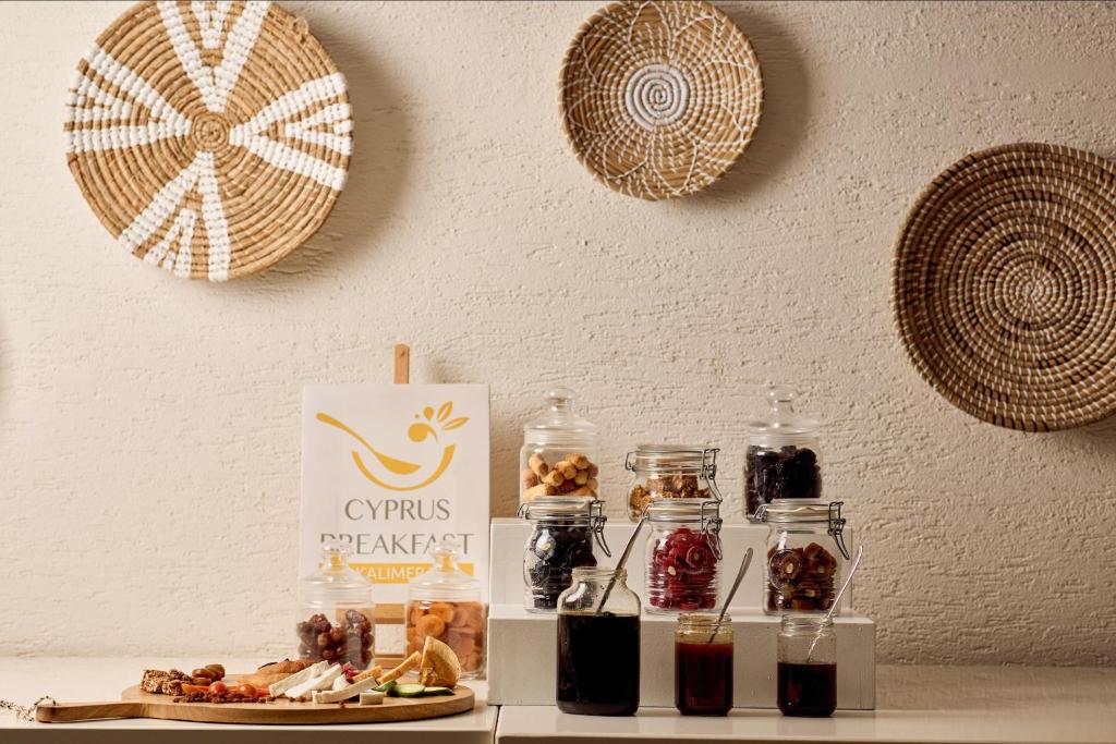 a table with some food and jars of jam at Nissi Park Hotel in Ayia Napa