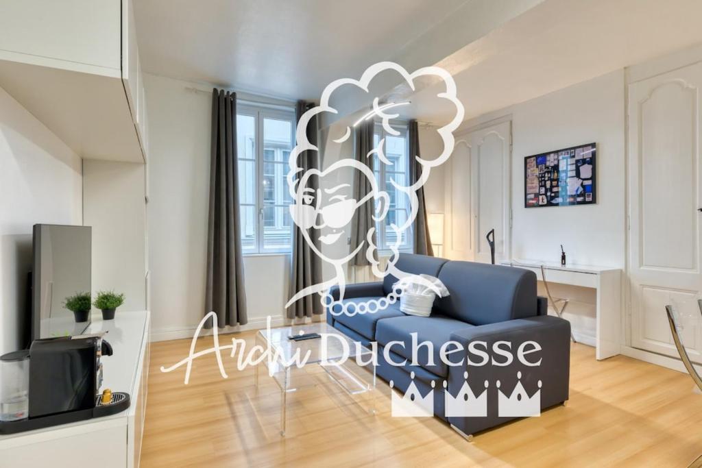 a living room with a blue couch and a balloon at Le Gainsbourg studio coeur de Rouen ! in Rouen