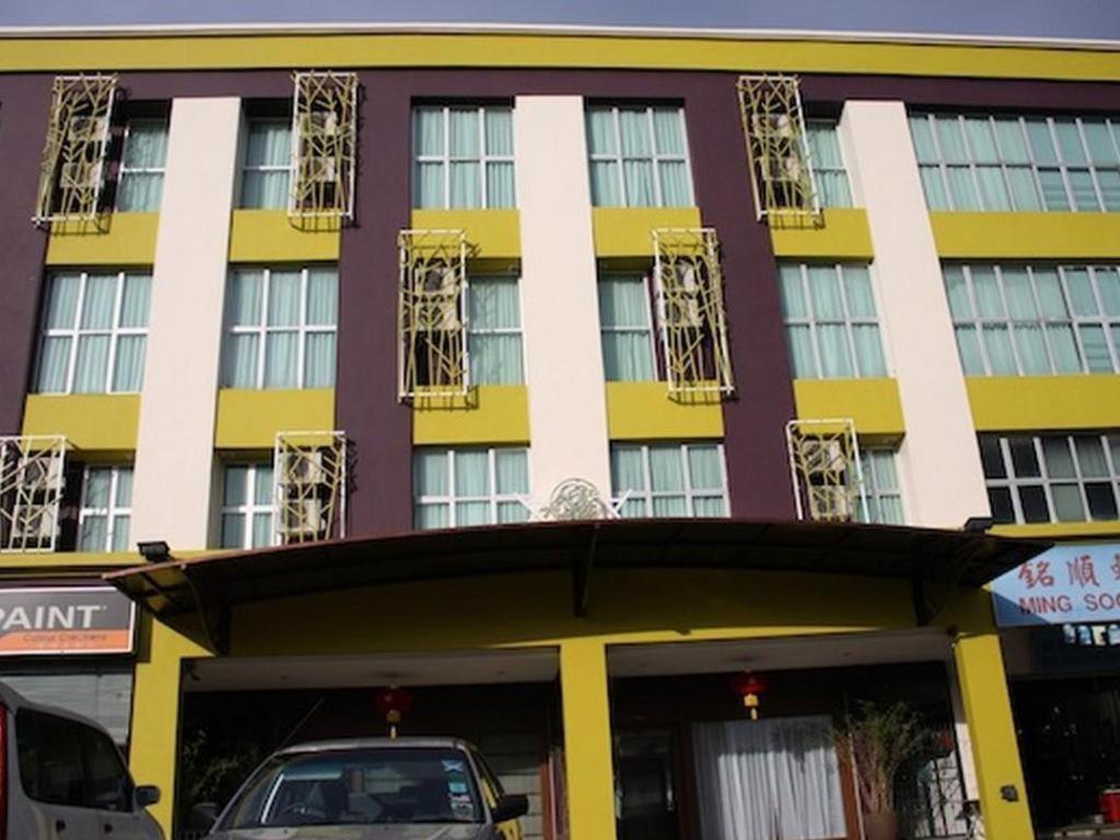クチンにあるGrand Medallion Hotelの黄白の建物