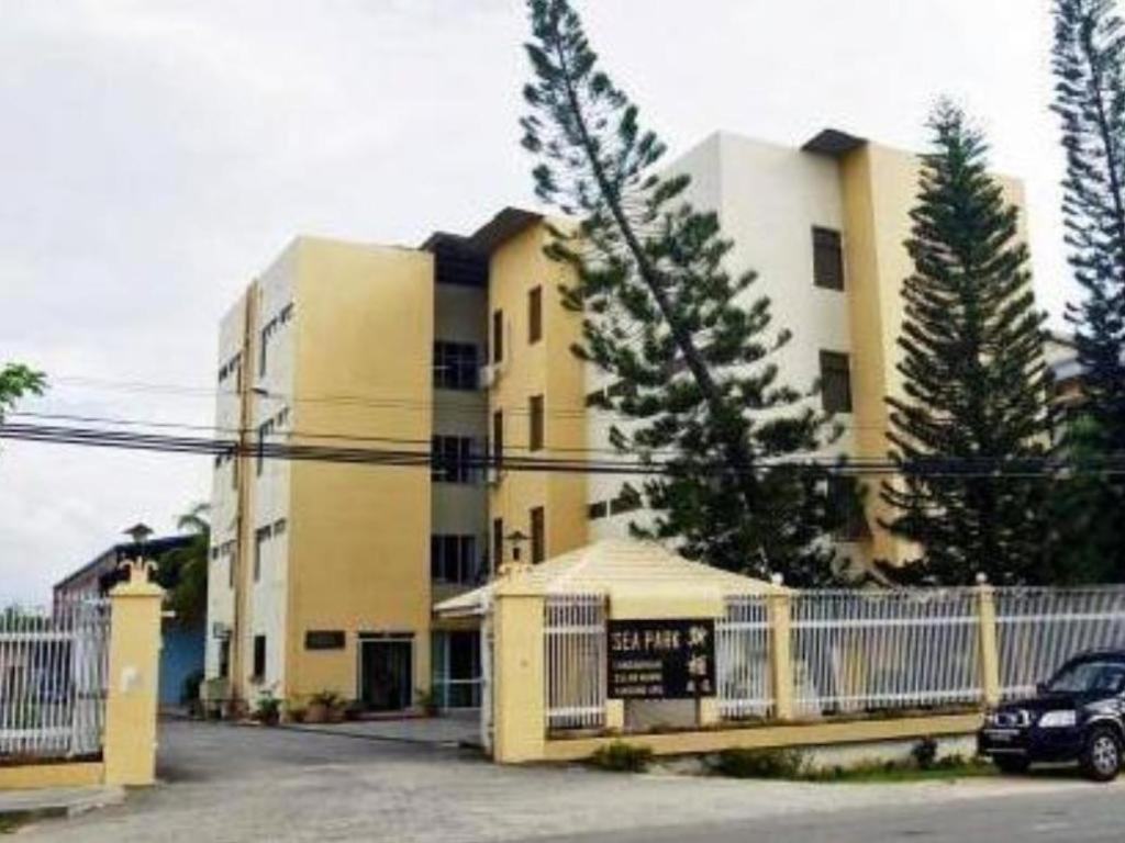 a building with a car parked in front of it at Seapark Condotel Hotel in Tanjong Aru