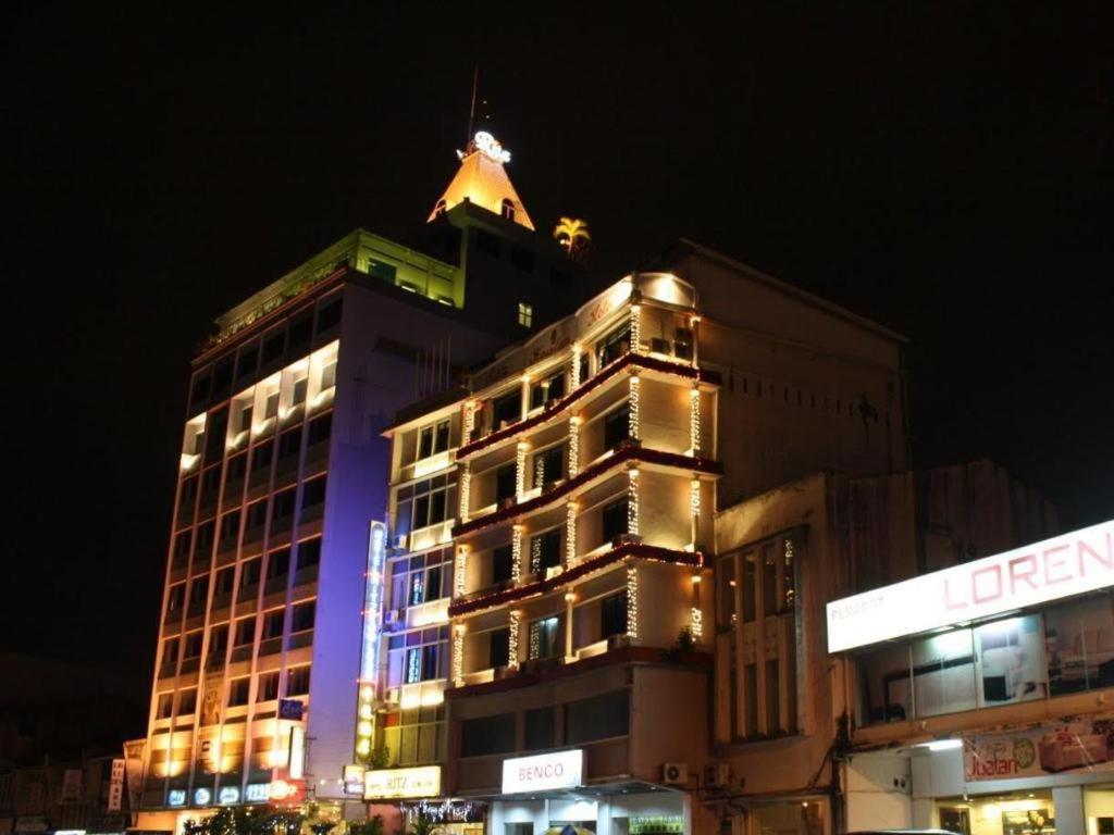 a building with a dog on top of it at night at Ritz Garden Hotel in Ipoh