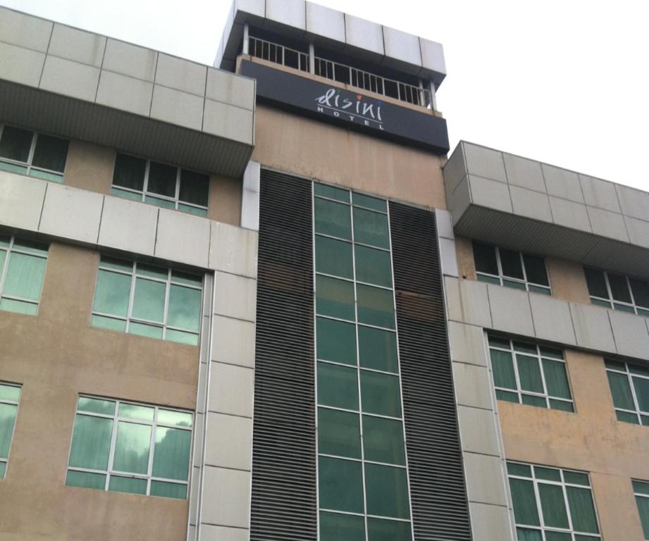a building with a sign on the side of it at Disini Hotel in Kampong Sembulan