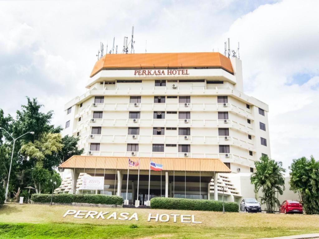 a hotel in front of a large building at Perkasa Hotel Keningau in Baginda