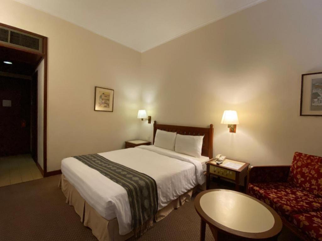 a hotel room with a bed and a couch at Marco Polo Hotel - Tawau in Tawau