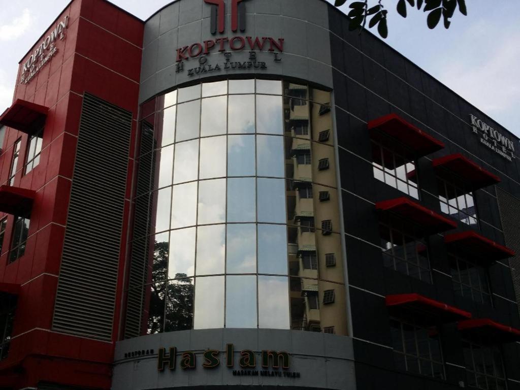 a red and black building with a sign on it at Hotel Zamburger Bangsar (Previously Koptown Hotel Bangsar) in Kuala Lumpur
