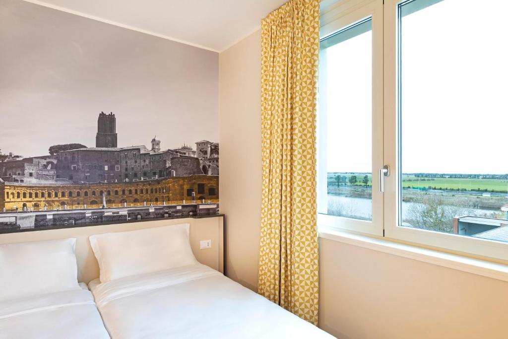 Postel nebo postele na pokoji v ubytování B&B Hotel Roma Fiumicino Aeroporto Fiera 1