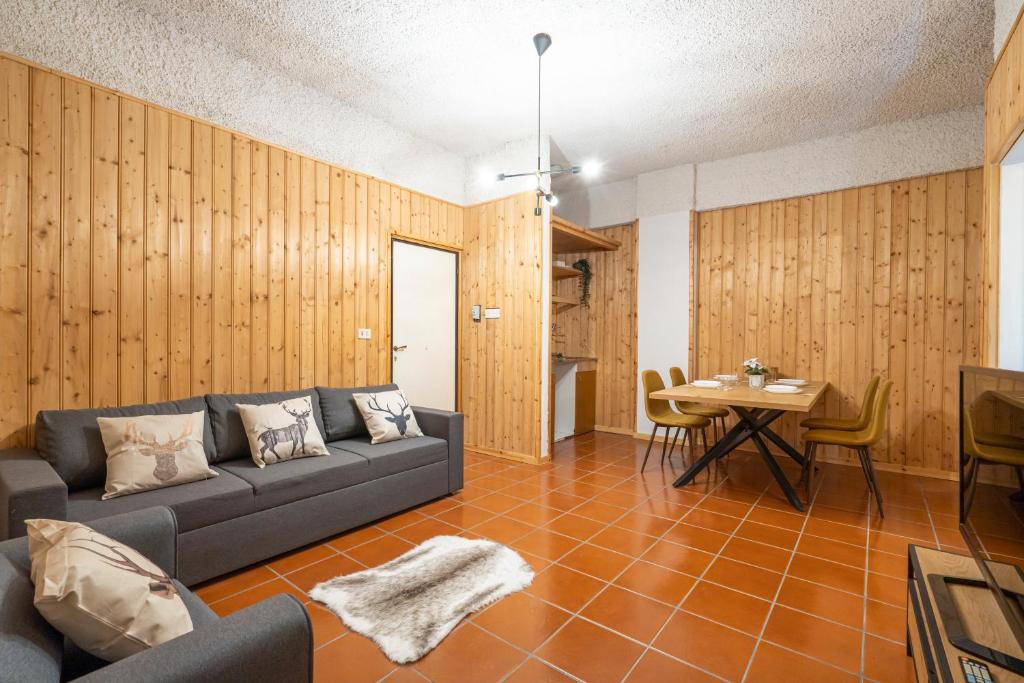 a living room with a couch and a table at Campo Felice Apartment in Casamaina