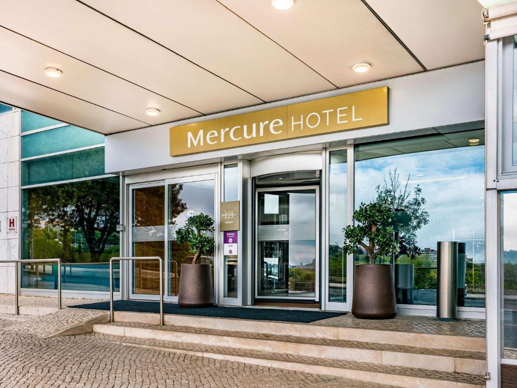 an entrance to a hotel with a sign on it at Mercure Lisboa Almada in Almada