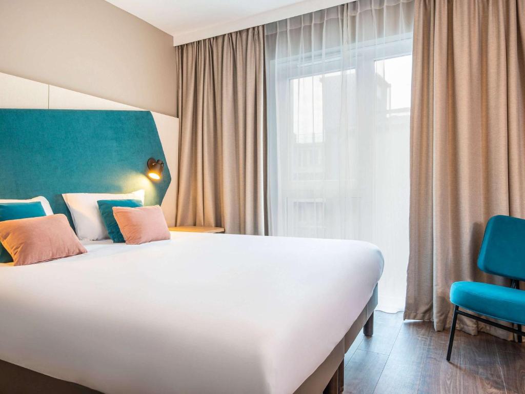 Postel nebo postele na pokoji v ubytování Aparthotel Adagio Heidelberg