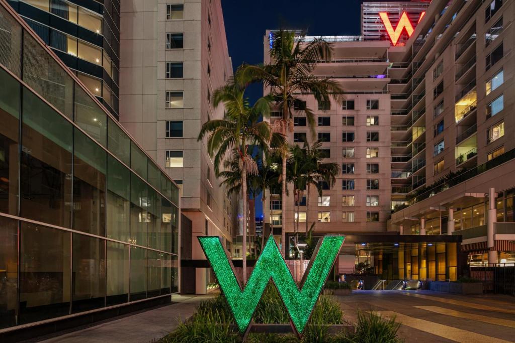 a building with a green w sign in front of it at W Hollywood in Los Angeles