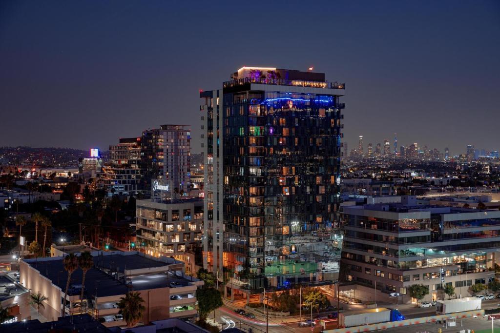 a tall building with lights on top of it at night at W Hollywood in Los Angeles