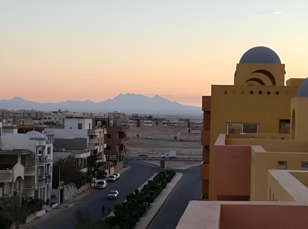 a view of a city with mountains in the background at Al-Dora Resort Hurghada in Hurghada