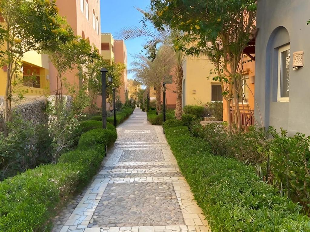 a cobblestone path between two buildings at Al-Dora Resort Hurghada in Hurghada