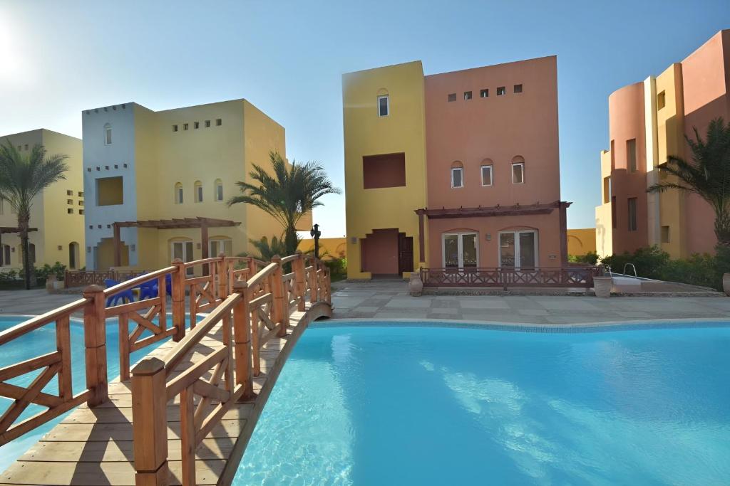 a resort with a swimming pool in front of some buildings at Al-Dora Resort Hurghada in Hurghada