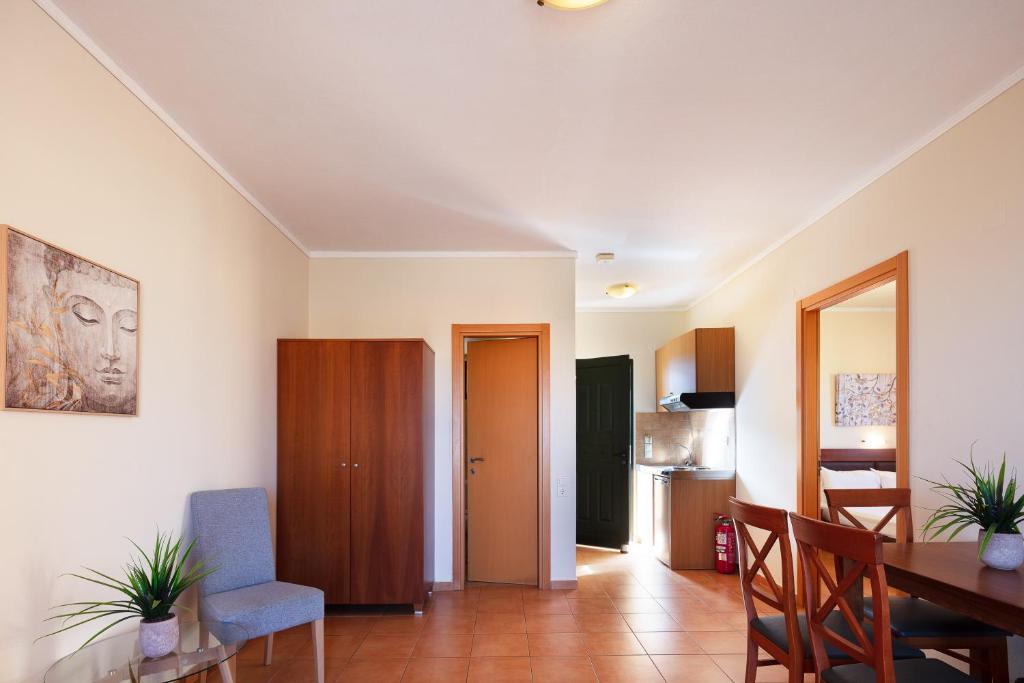 a living room with a table and a dining room at Dia Apartments in Hersonissos