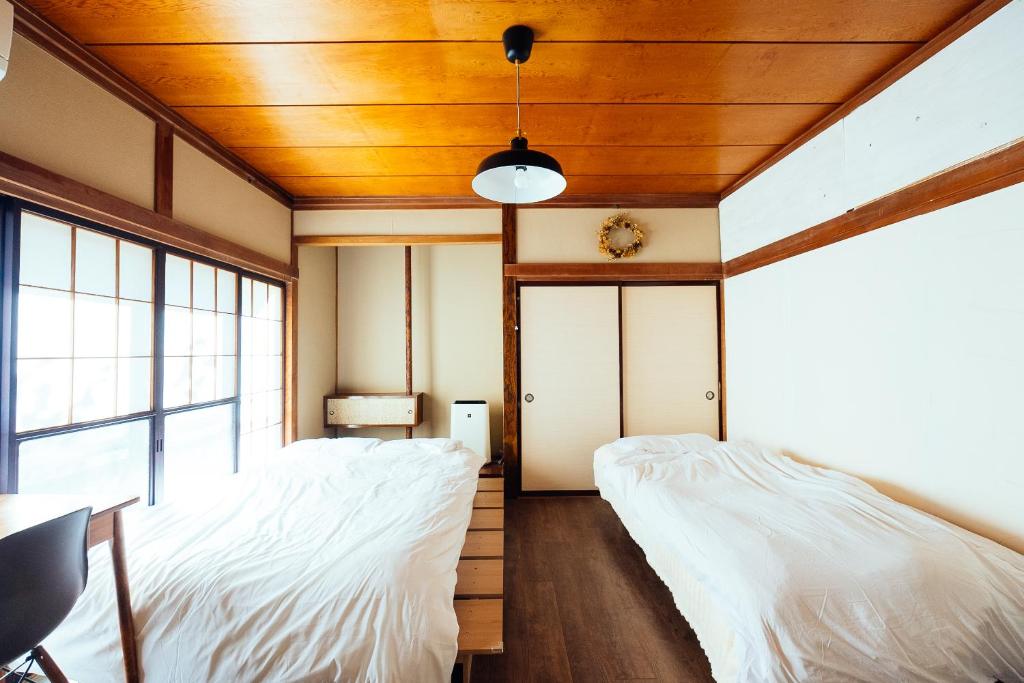 Postel nebo postele na pokoji v ubytování yururito guesthouse