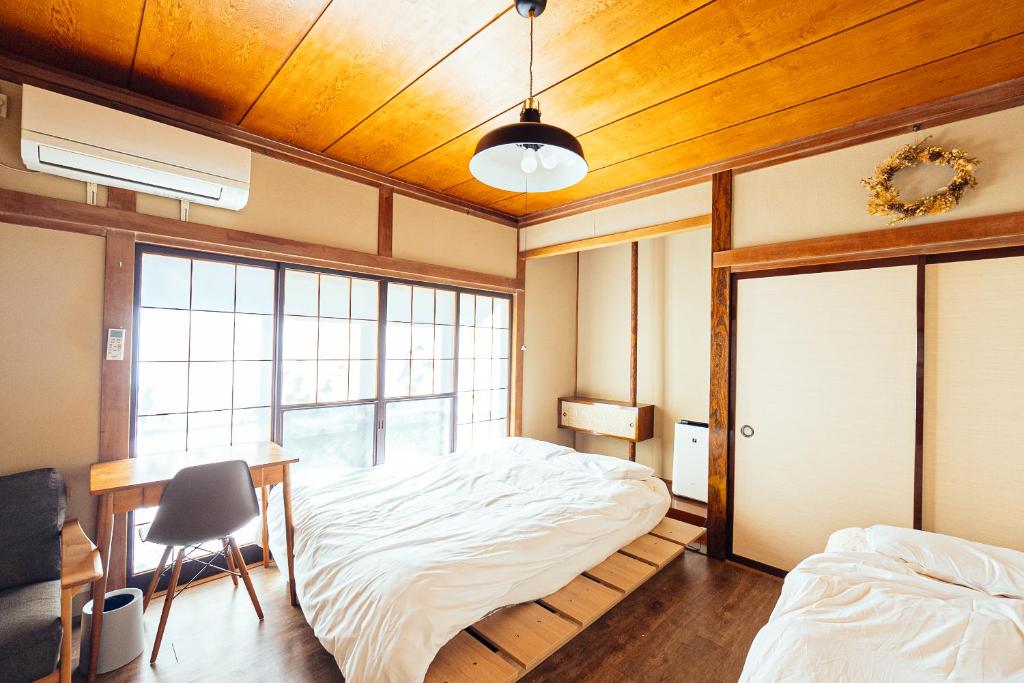 Postel nebo postele na pokoji v ubytování yururito guesthouse